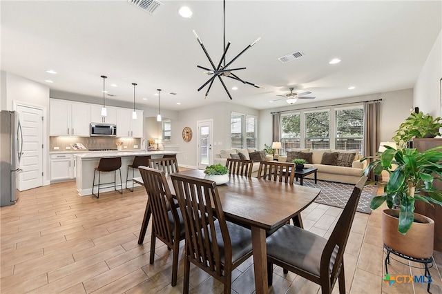 dining area featuring light wood-type flooring, visible vents, and recessed lighting