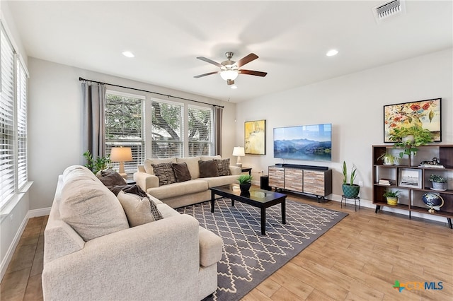 living area featuring ceiling fan, recessed lighting, wood finished floors, visible vents, and baseboards