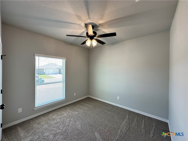 carpeted spare room with a textured ceiling and ceiling fan