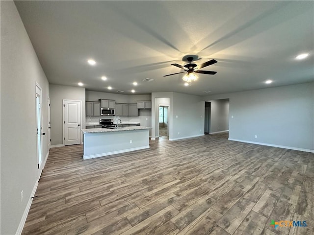 3110 Gryffindor Ln, Killeen, TX 76549 - kitchen with gray cabinetry, baseboards, recessed lighting, dark wood-type flooring, and ceiling fan