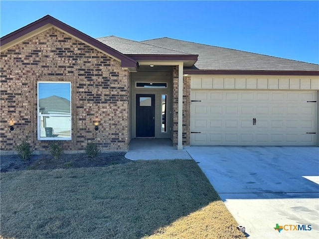 view of front facade with a garage and a front lawn