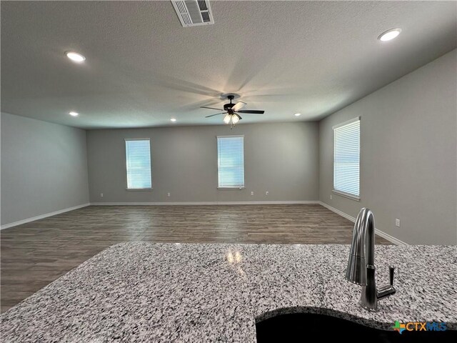 kitchen with a wealth of natural light, a center island with sink, sink, and dishwasher