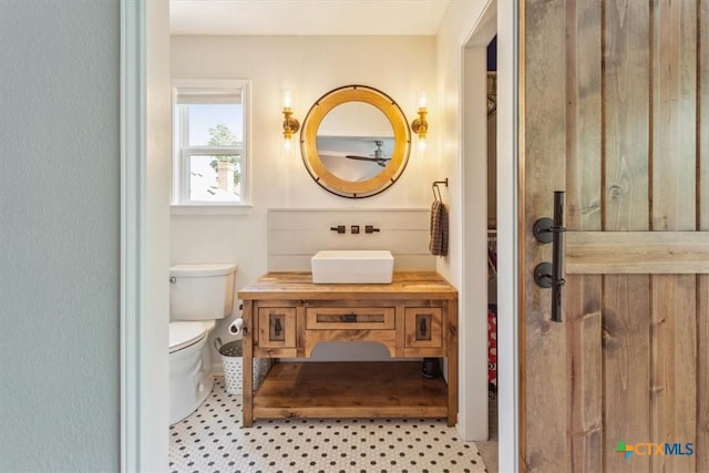bathroom featuring toilet and vanity