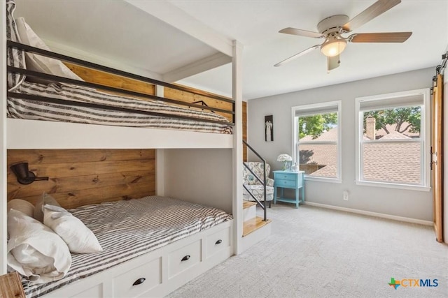 bedroom featuring a ceiling fan, baseboards, and light colored carpet
