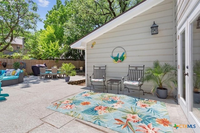 view of patio / terrace with outdoor dining area, fence, and an outdoor hangout area
