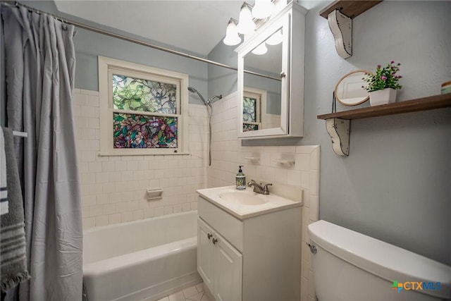 bathroom with vanity, shower / tub combo, tile patterned flooring, and toilet