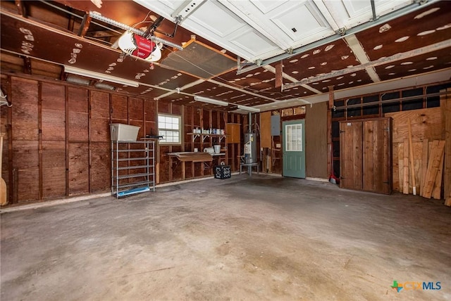 garage featuring a garage door opener and water heater