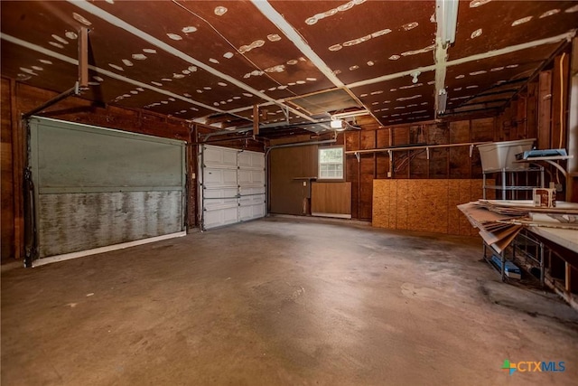 garage featuring wooden walls