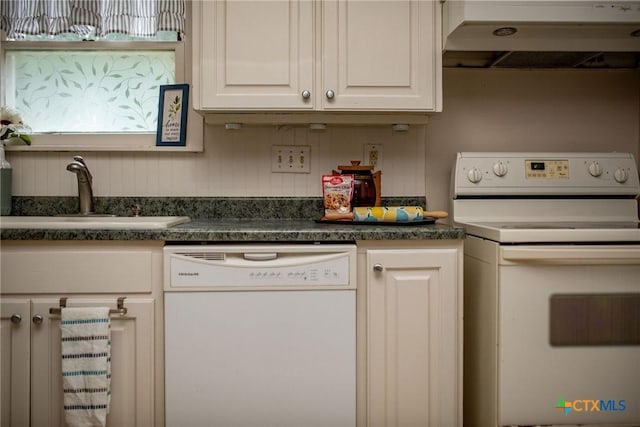 kitchen with white appliances, dark countertops, under cabinet range hood, and a sink