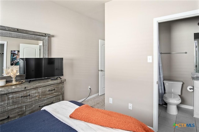 tiled bedroom featuring ensuite bathroom