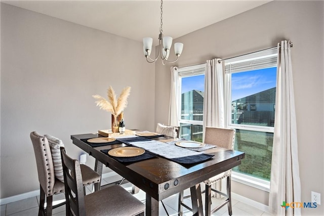 dining area with a chandelier, a wealth of natural light, and light tile patterned flooring