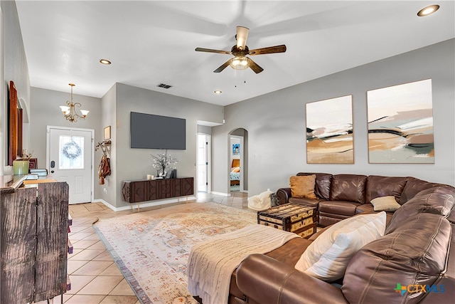 living room with light tile patterned floors and ceiling fan with notable chandelier