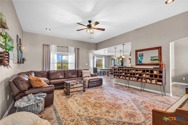 living room with ceiling fan and light tile patterned floors