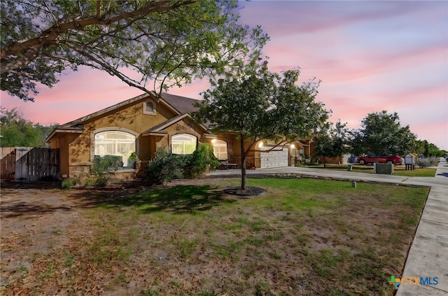 view of front facade with a lawn and a garage