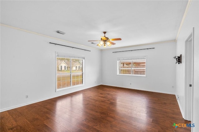 unfurnished room featuring crown molding, dark wood-type flooring, and ceiling fan