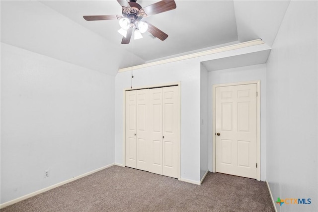 unfurnished bedroom featuring ceiling fan, a closet, lofted ceiling, and carpet