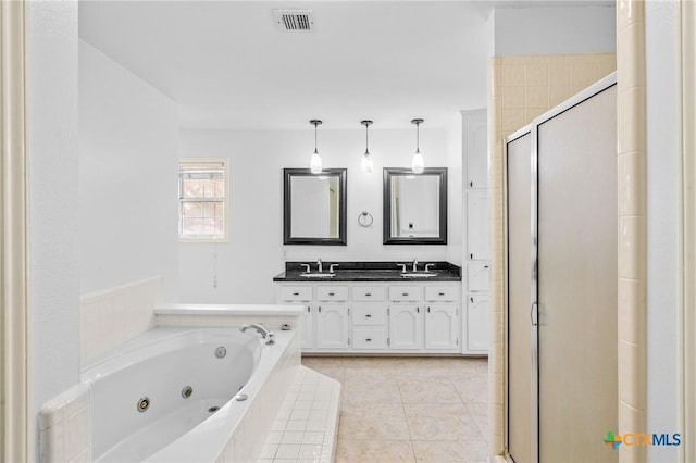 bathroom featuring tile patterned floors, vanity, and plus walk in shower