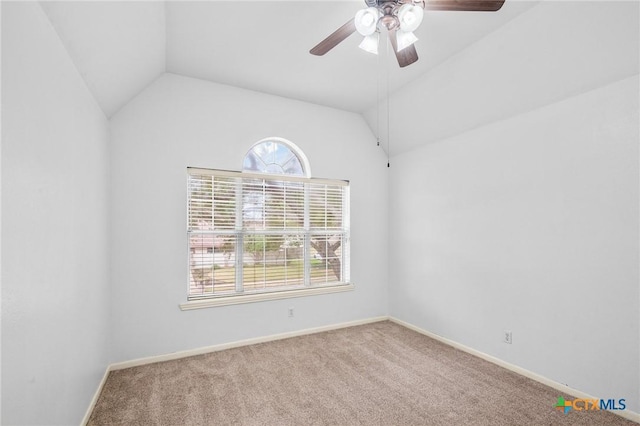 carpeted spare room featuring ceiling fan, lofted ceiling, and a wealth of natural light