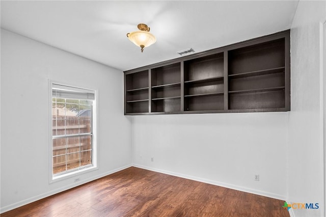 empty room featuring dark wood-type flooring