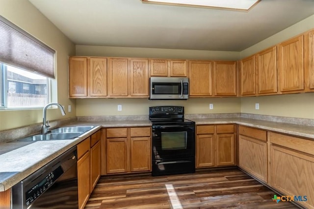 kitchen with dark wood-type flooring, sink, and black appliances