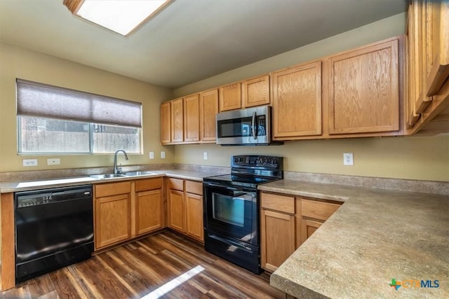 kitchen with dark hardwood / wood-style flooring, sink, and black appliances