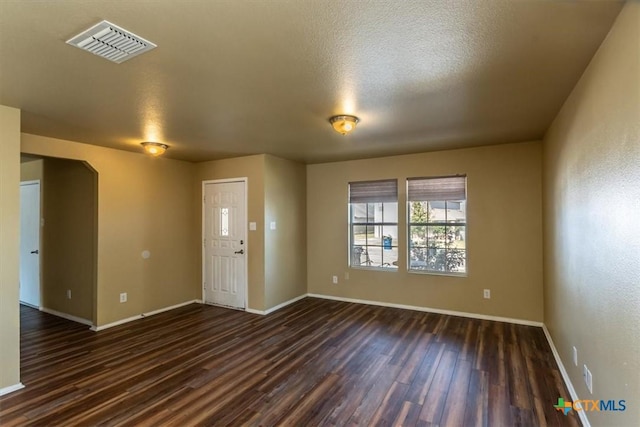 interior space featuring dark hardwood / wood-style flooring and a textured ceiling