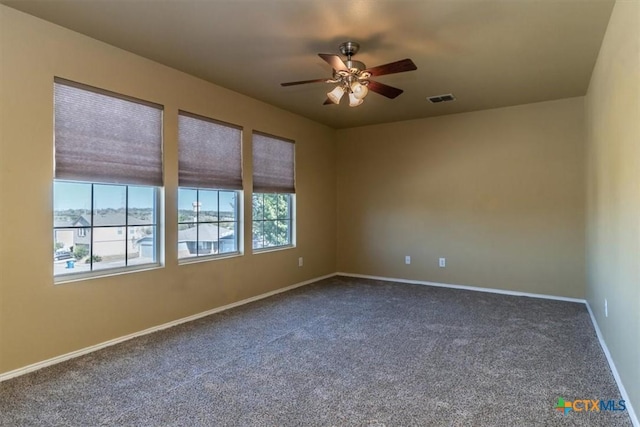 carpeted spare room with ceiling fan