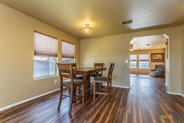 dining space featuring ceiling fan and dark wood-type flooring