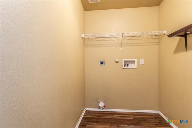 clothes washing area featuring hookup for an electric dryer, hookup for a washing machine, dark hardwood / wood-style flooring, and gas dryer hookup