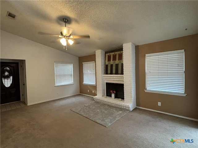 unfurnished living room with visible vents, a brick fireplace, carpet, ceiling fan, and lofted ceiling