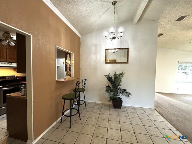 hallway featuring light tile patterned floors, light colored carpet, a textured ceiling, and vaulted ceiling with beams