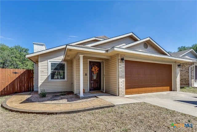 ranch-style home featuring brick siding, fence, concrete driveway, a chimney, and a garage