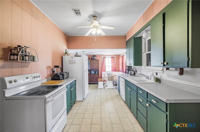 408 Frobese St, Cuero, TX 77954 - kitchen featuring appliances with stainless steel finishes, green cabinets, ceiling fan, and light countertops