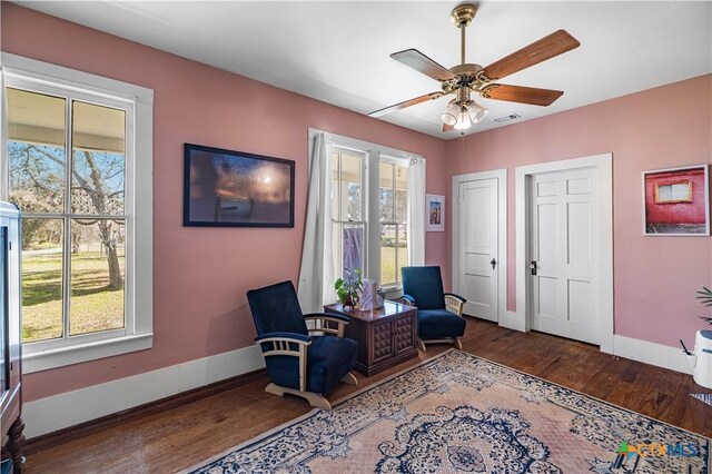408 Frobese St, Cuero, TX 77954 - living area featuring healthy amount of natural light, wood finished floors, ceiling fan, and a desk