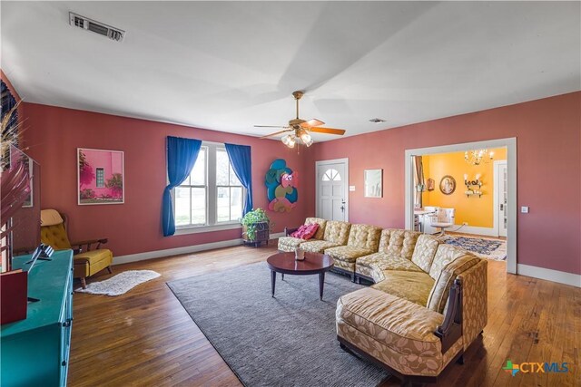 408 Frobese St, Cuero, TX 77954 - living area featuring a chandelier, hardwood / wood-style floors, and a ceiling fan