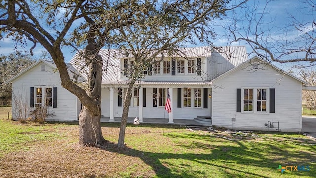 view of front of property with covered porch and a front lawn