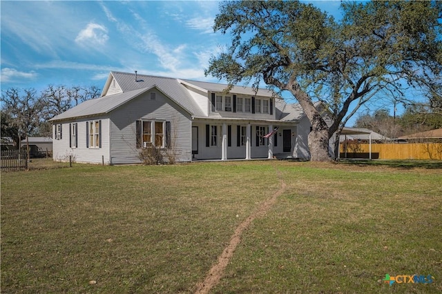 rear view of house with a carport and a yard