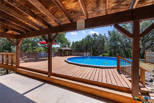 view of swimming pool with a gazebo and a deck