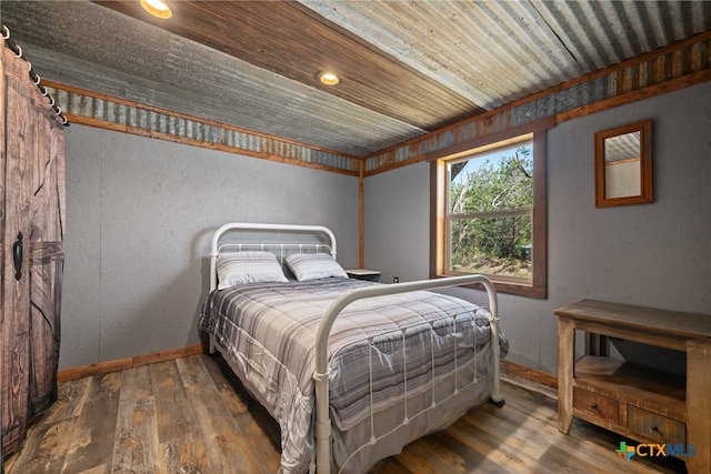 bedroom featuring hardwood / wood-style floors and wooden ceiling