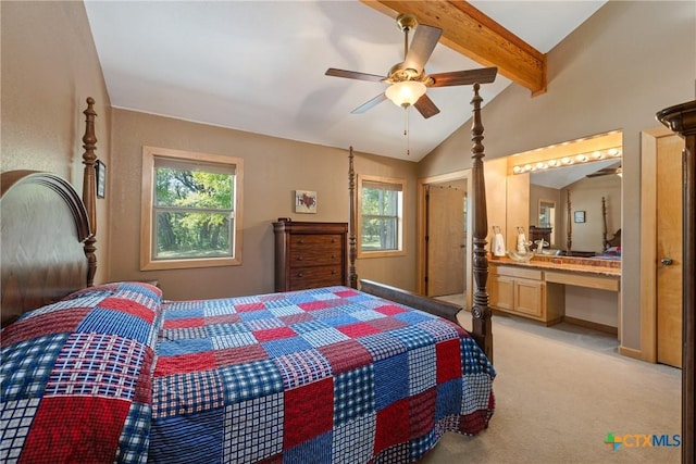 carpeted bedroom with ceiling fan, connected bathroom, and vaulted ceiling with beams