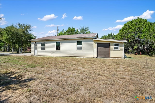 rear view of house featuring a yard