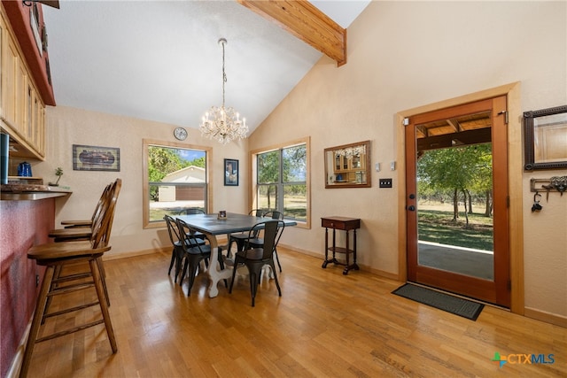 dining space with an inviting chandelier, beam ceiling, high vaulted ceiling, and light wood-type flooring