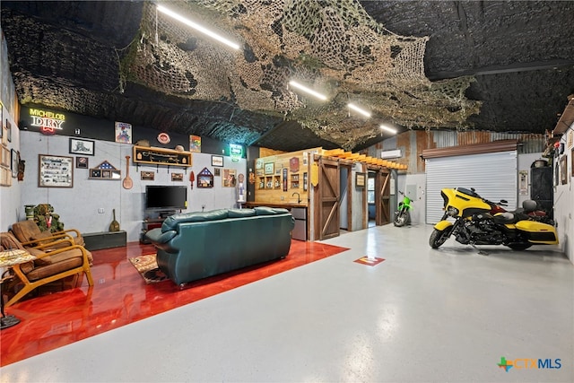 interior space featuring concrete flooring and a wall unit AC