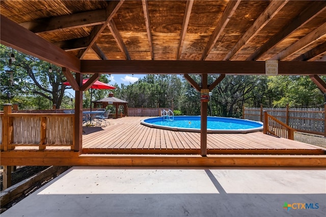 view of pool with a gazebo and a deck