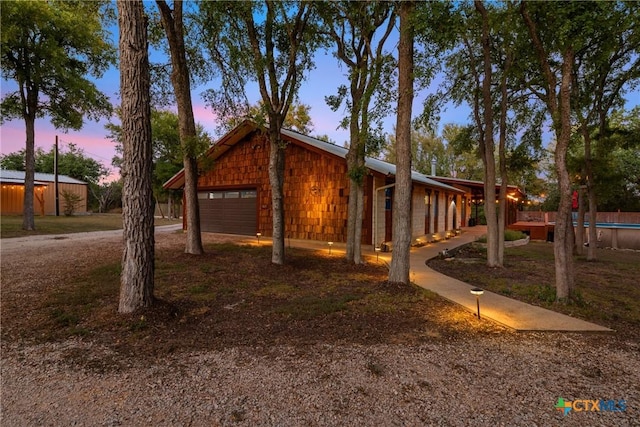 view of front of home with a garage and an outdoor structure