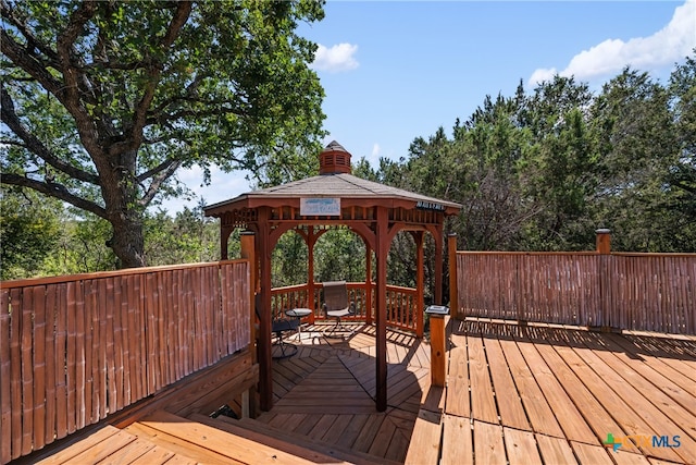 wooden terrace featuring a gazebo