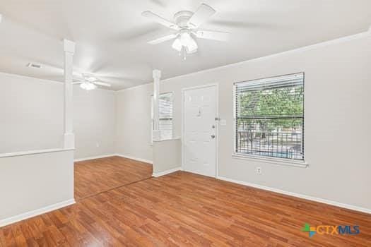 1624 Aquarena Springs Dr Unit G152, San Marcos, TX 78666 - unfurnished room with ceiling fan, wood finished floors, baseboards, and crown molding
