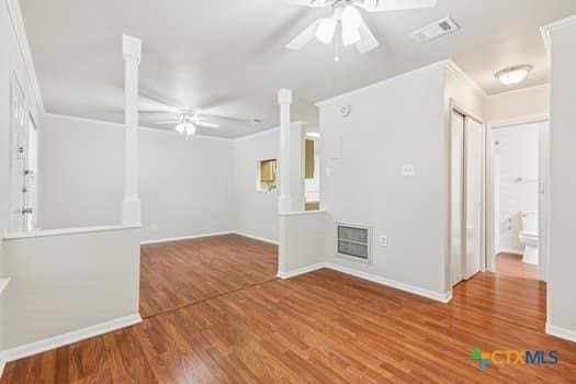 1624 Aquarena Springs Dr Unit G152, San Marcos, TX 78666 - empty room featuring ceiling fan, wood finished floors, ornamental molding, and baseboards