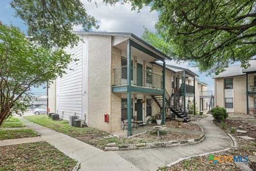 1624 Aquarena Springs Dr Unit G152, San Marcos, TX 78666 - view of building exterior featuring stairway and cooling unit