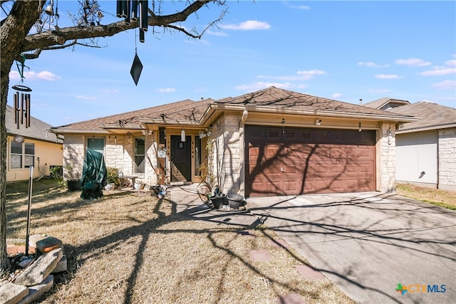 view of front facade featuring a garage, driveway, and stone siding